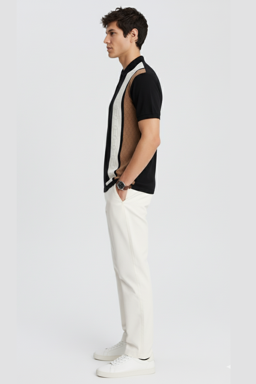 Man wearing a black and white outfit on a plain background