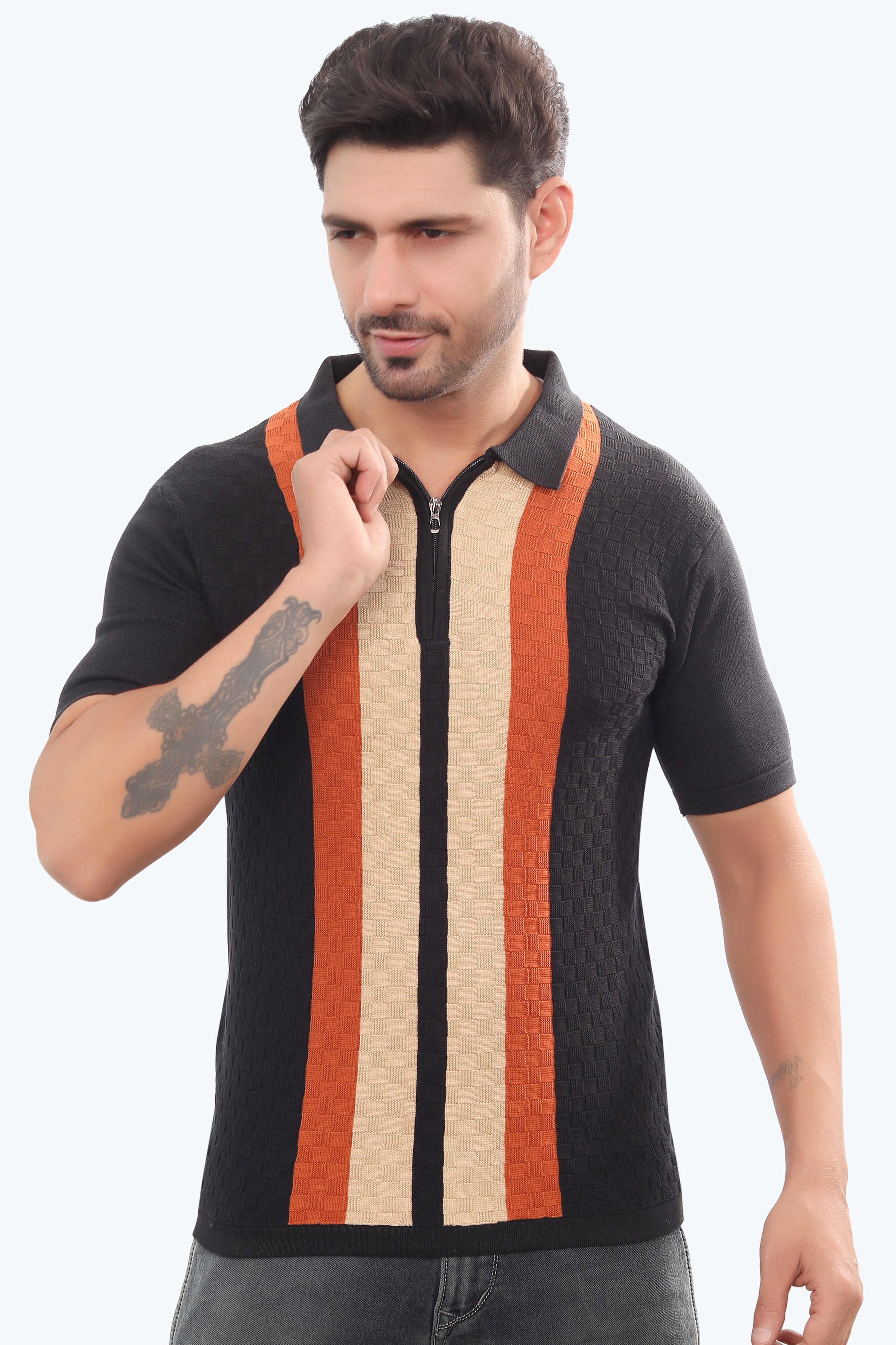 Man wearing a black polo shirt with colorful vertical stripes on a white background