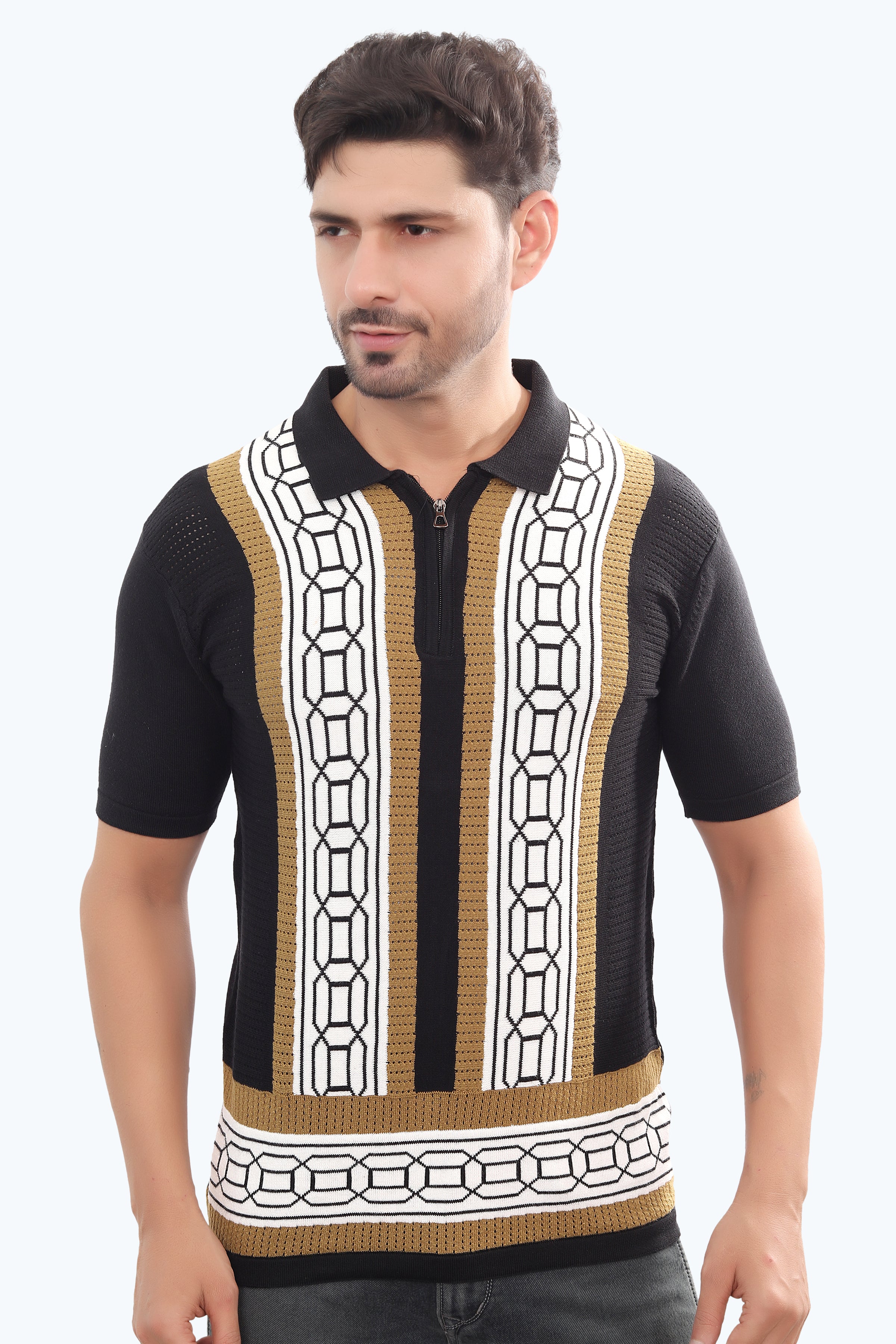 Man wearing a black short-sleeve shirt with a geometric pattern on a white background