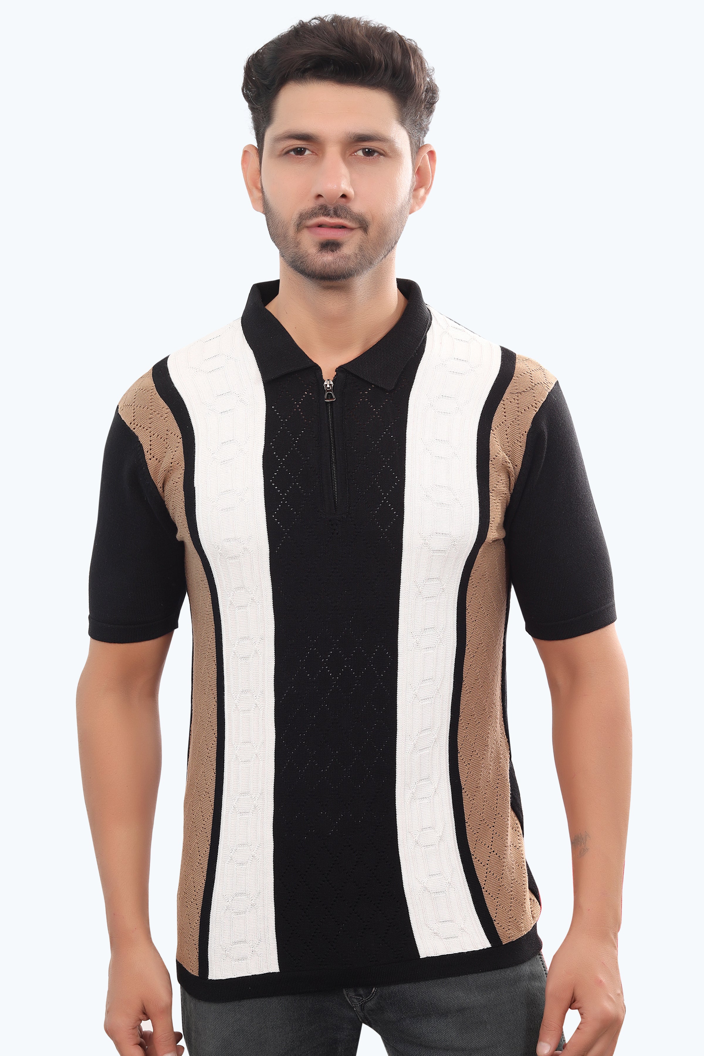 Man wearing a black and white striped shirt with a patterned sleeve on a white background