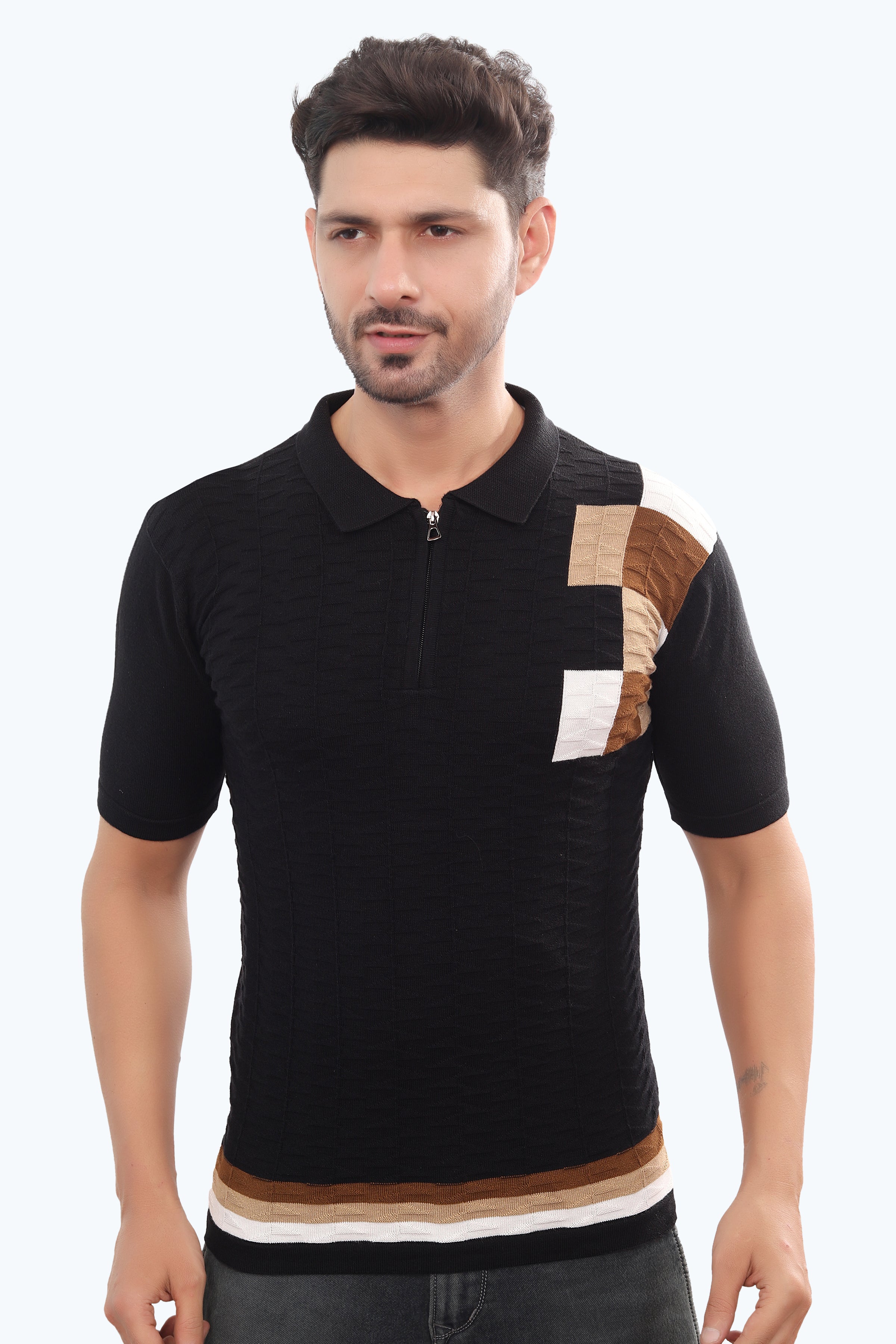 Man wearing a black polo shirt with color-blocked sleeves on a white background