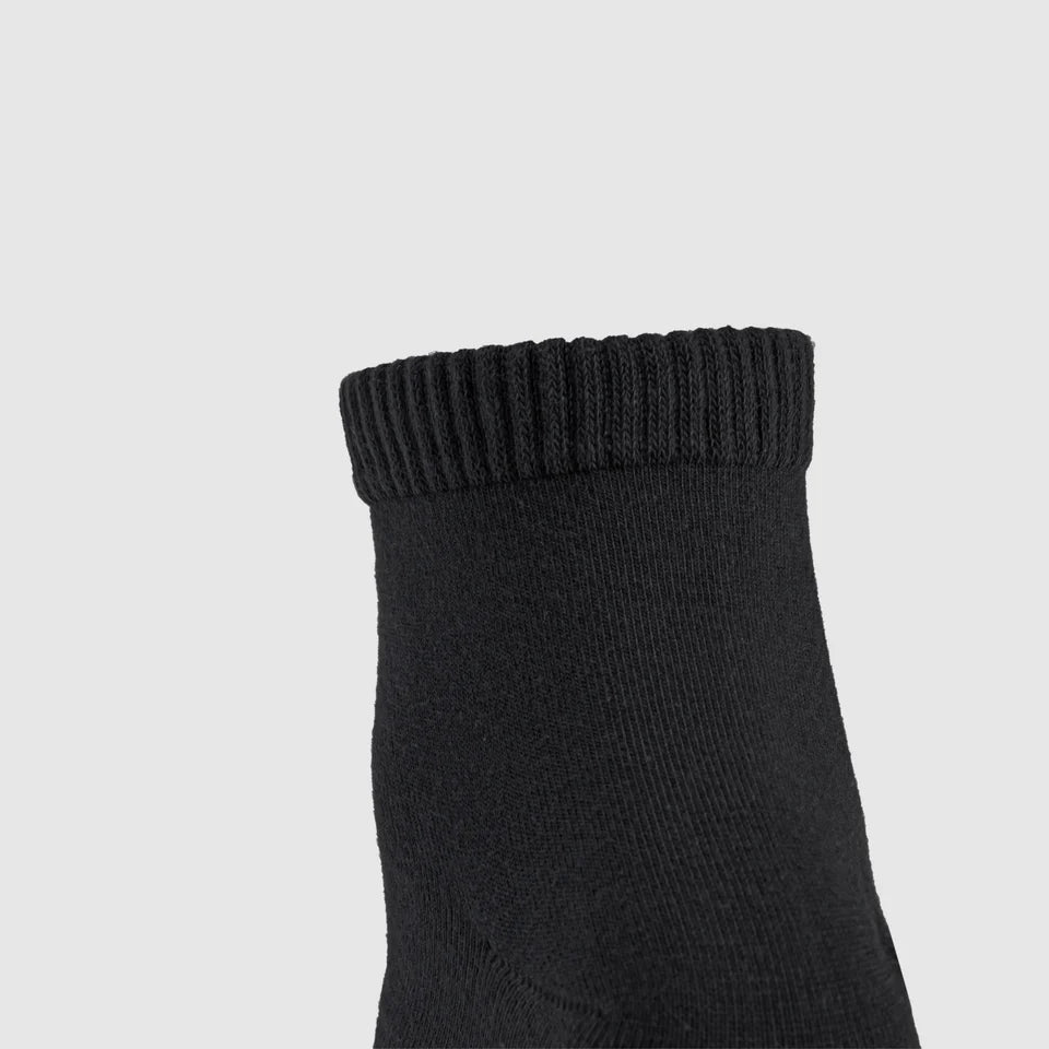 Close-up of black sock with ribbed cuff.
