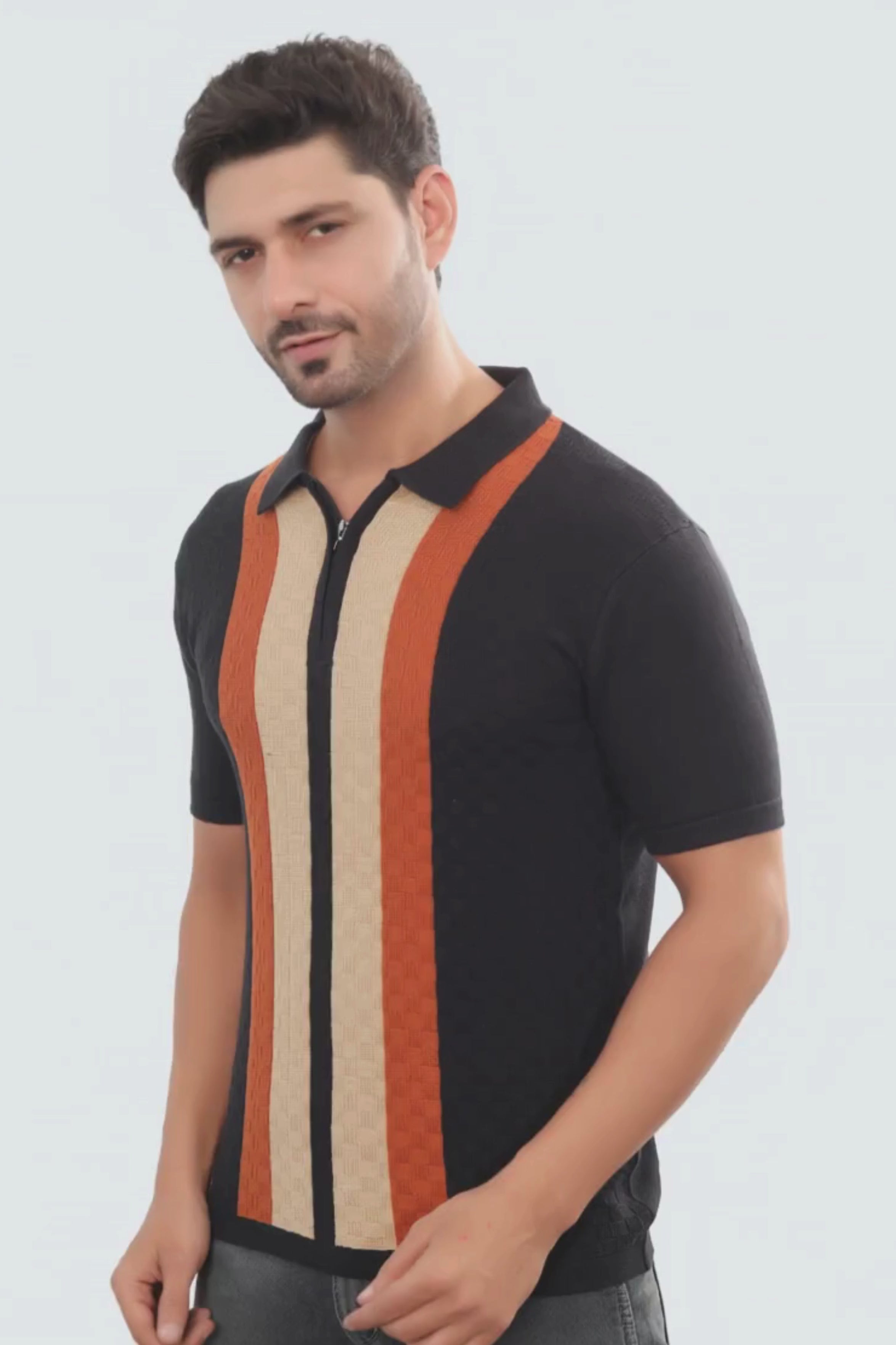 Man wearing a black polo shirt with colorful vertical stripes on a white background