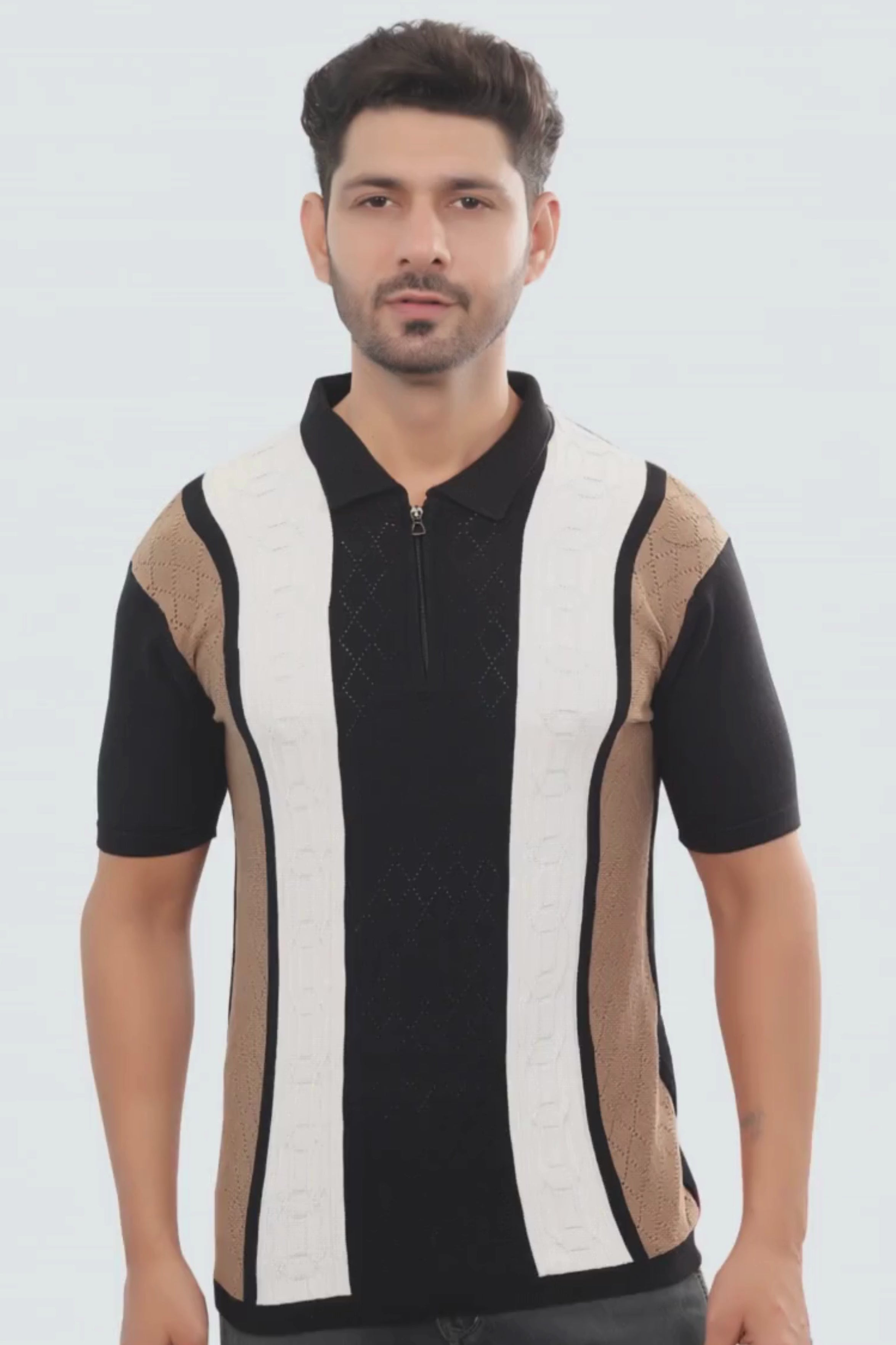 Man wearing a black and white striped shirt with a patterned sleeve on a white background